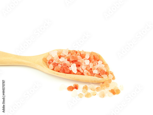 Himalayan pink salt in wooden scoop isolated on a white background. Close up with copy space for your text. .