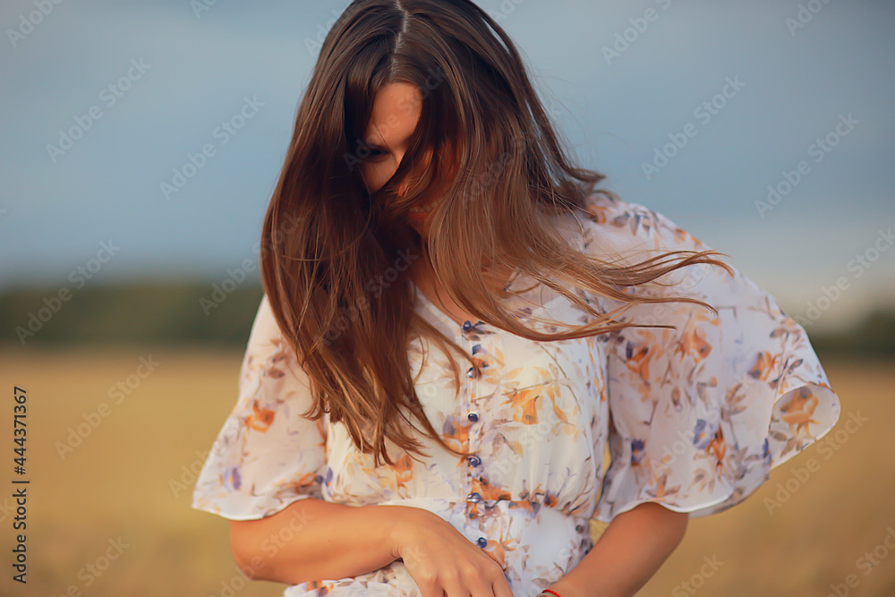 young brunette in summer with long hair in a field, happy person health beauty posing at sunset young brunette in summer with long hair in a field, happy person health beauty posing at sunset