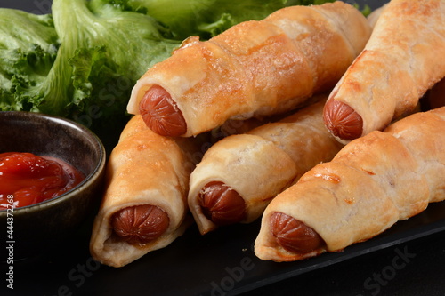 Sausage buns. Soft baked bun (dough )stuffed with pork sausage for fast food breakfast or coffee break. Sausage roll, (hot dog).