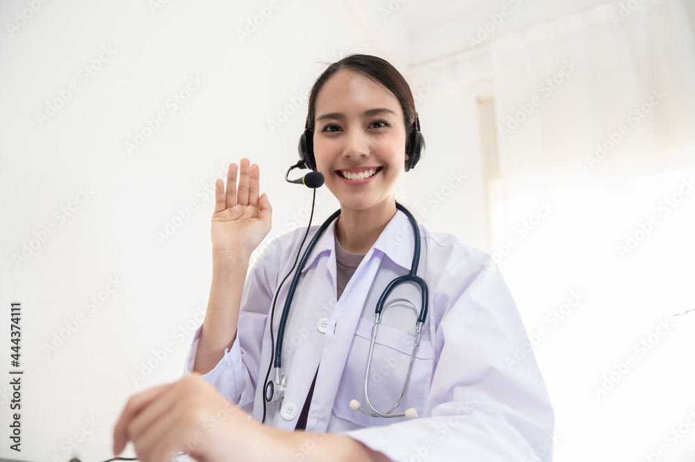 Portrait photo of young beautiful Asian doctor video remote conference call online with patient for social distancing due to covid-19 pandemic. Technology, health care new normal online telehealth. Portrait photo of young beautiful Asian doctor video remote conference call online with patient for social distancing due to covid-19 pandemic. Technology, health care new normal online telehealth.