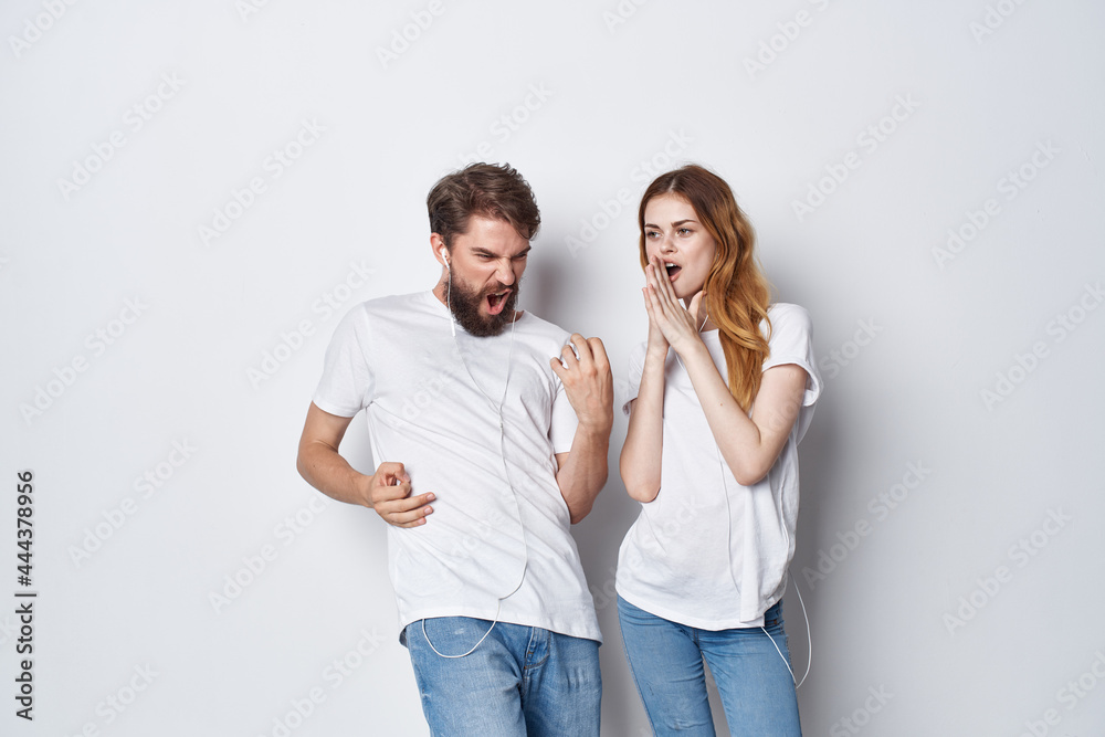 cheerful young couple in white t-shirts having fun together friendship