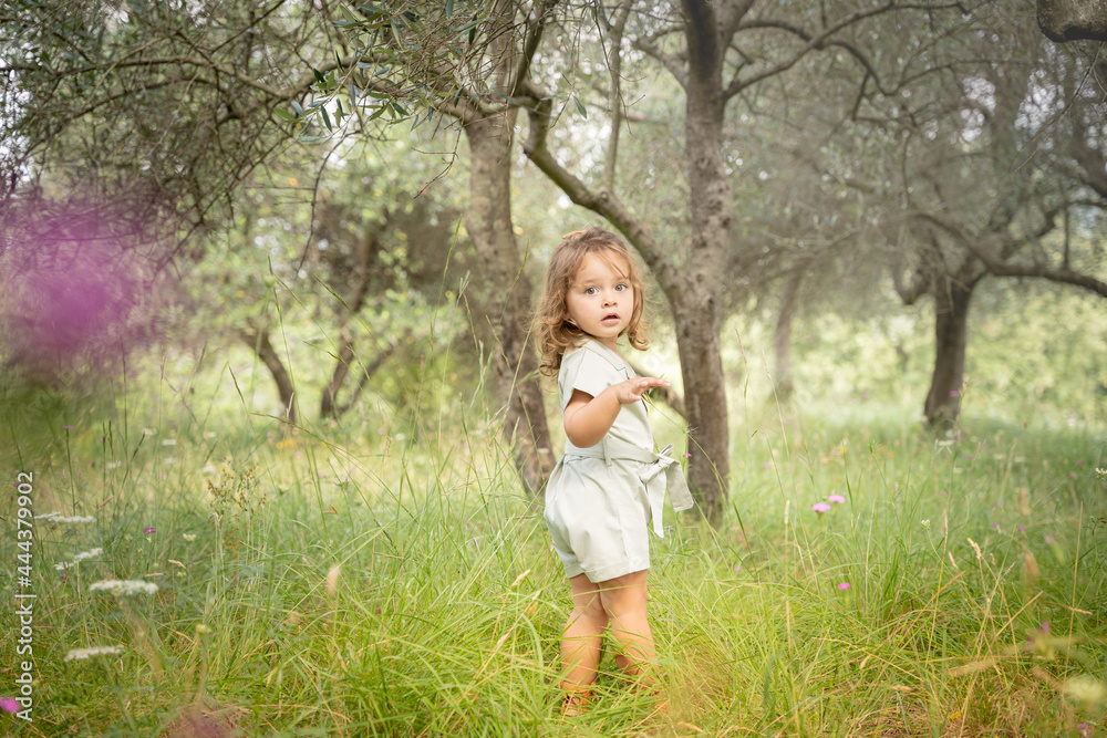 Pretty baby girl walking in a park Pretty baby girl walking in a park