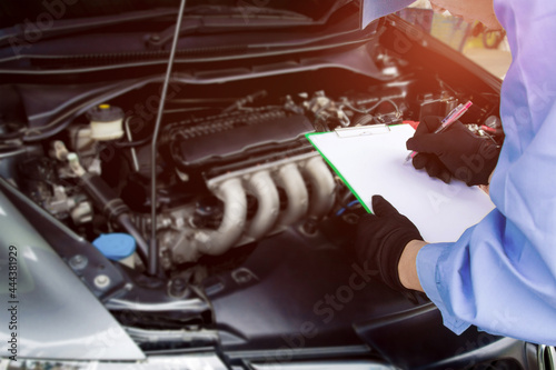 Mechanic hold check sheet paper for basic concept of car maintenance and service check