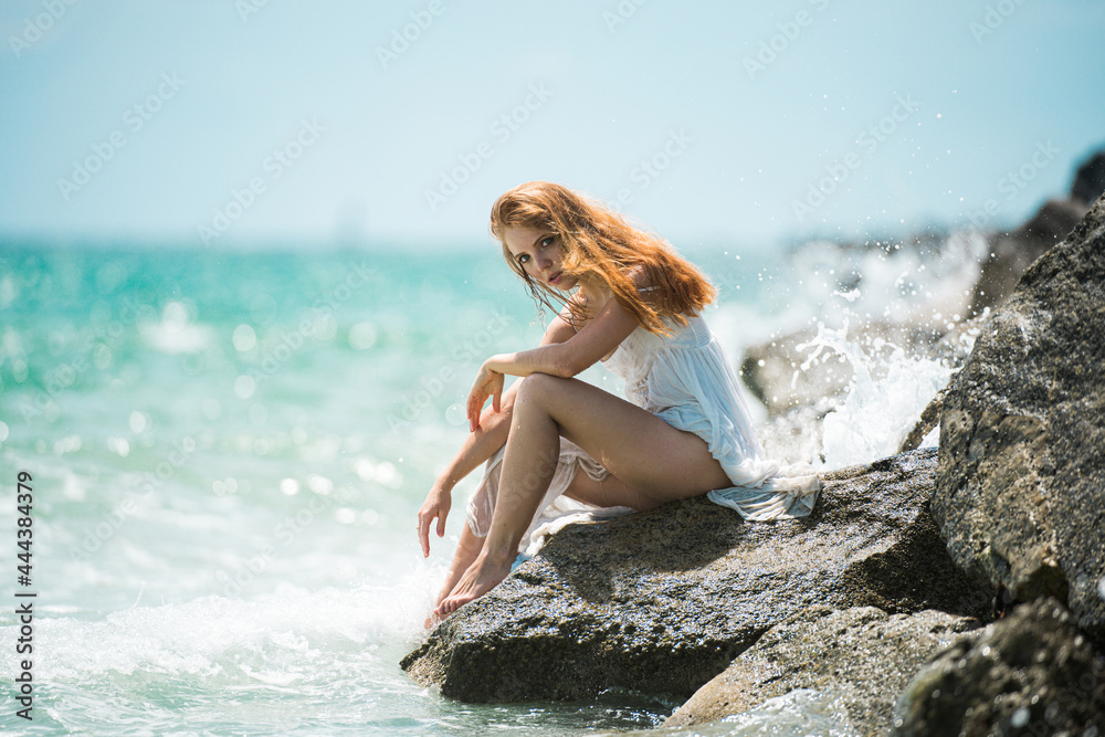 Young attractive girl with perfect body on the tropical summer beach. Sexy woman on sea, sensual female model posing near ocean background with copy space. Young attractive girl with perfect body on the tropical summer beach. Sexy woman on sea, sensual female model posing near ocean background with copy space.