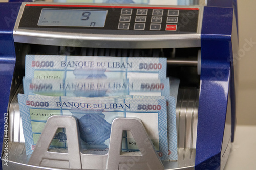 Lebanese Lira Currency being counted by a money counting machine photo