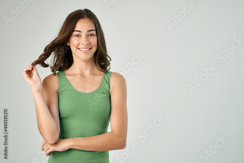 pretty brunette wearing green tank top fashion hairstyle smile cropped view