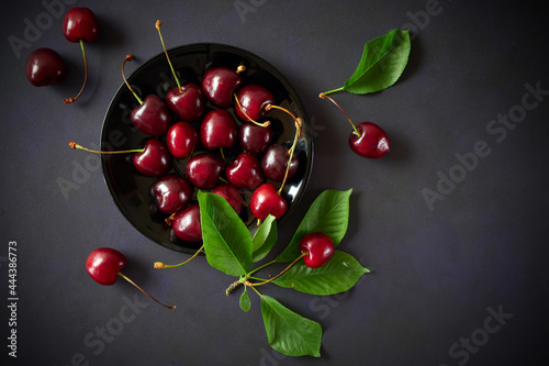 Ripe red cherries on a dark background