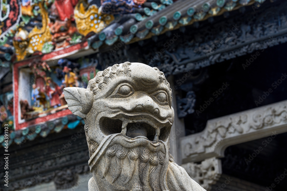 A close-up of a stone lion in the Chen Clan Temple in Guangzhou, stone carving art