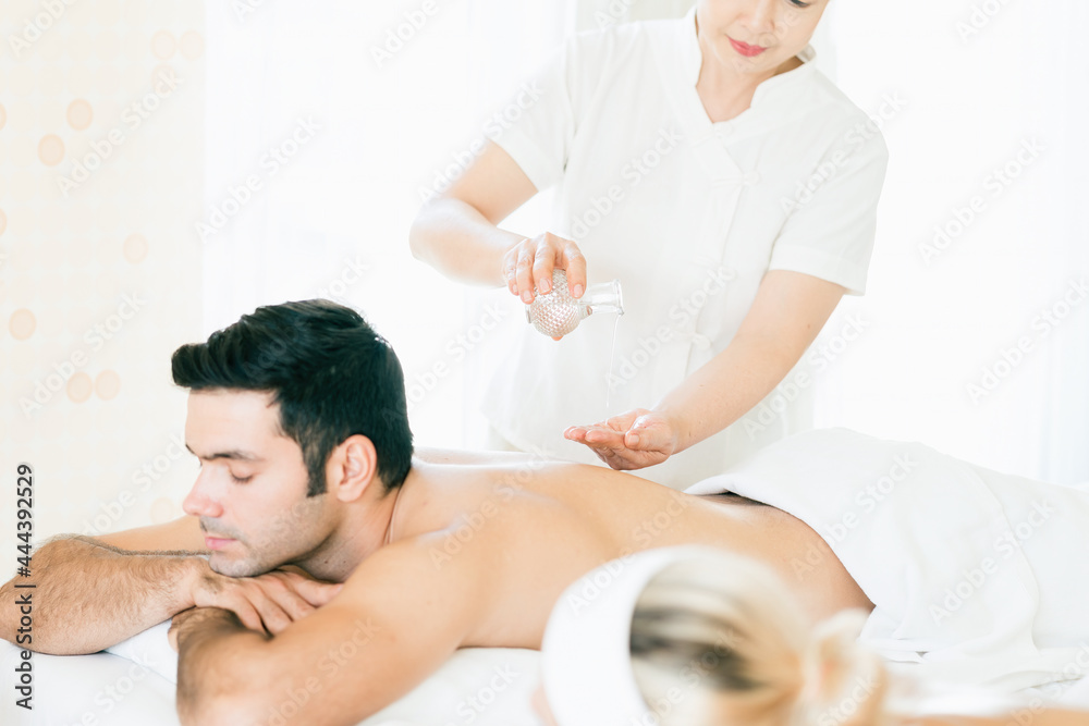 Young man getting oil massage. A massage therapist makes a man massage spa treatment health. Young man getting oil massage. A massage therapist makes a man massage spa treatment health.