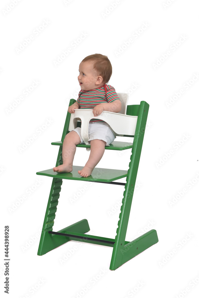 full portrait of a baby sitting in a highchair laughing on white background full portrait of a baby sitting in a highchair laughing on white background