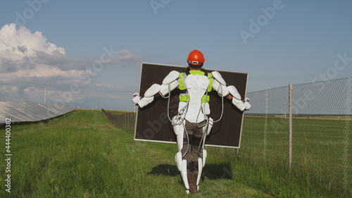 Unrecognizable engineer carrying photovoltaic panel