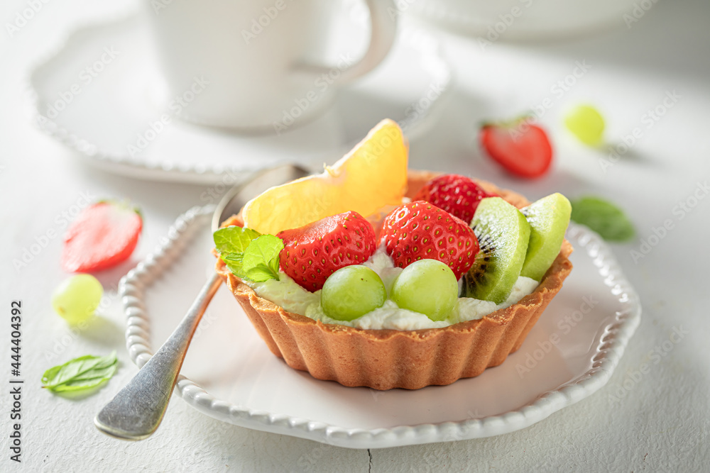 Homemade mini tart with fruits and cream. Sweet fruit dessert. Homemade mini tart with fruits and cream. Sweet fruit dessert.