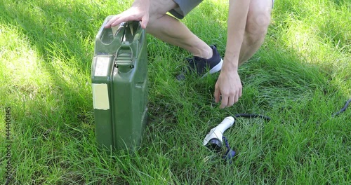 Man is standing and choosing electric charge cable with plug or gas canister selecting fuel type 