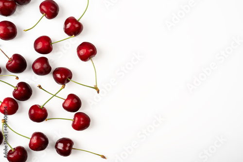 Frame of large ripe cherry berries on a white background