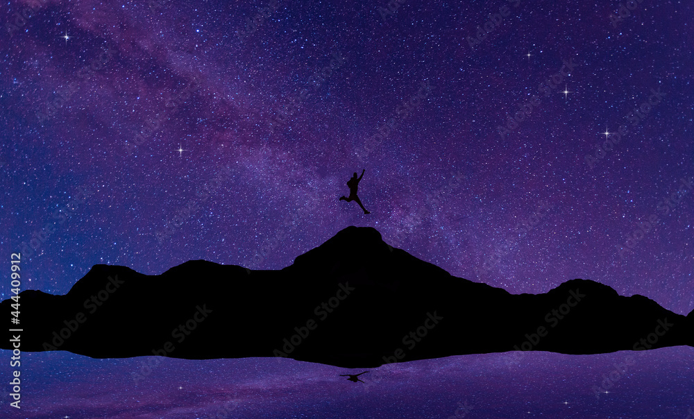 Silhouette of a black man jumping over a mountain,On the milky way background.Universe filled with stars, nebula and galaxy with noise and grain.select focus.Brave leader concept.