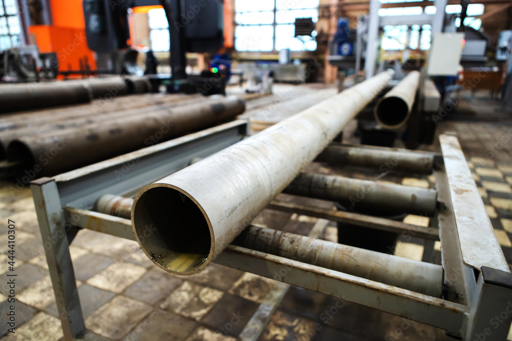 Manufacturing of steel pipes at a metallurgical plant. Selective focus