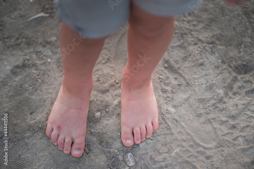 Baby feet playing in sand © Olena