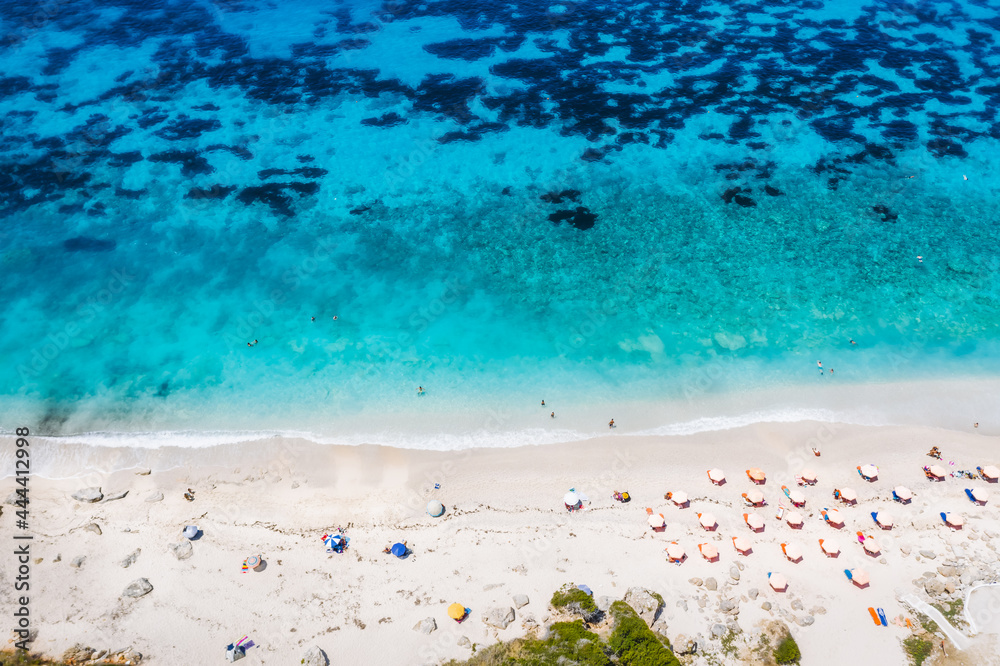 Aerial top down drone photo of Petani beach with beautiful turquoise sea and summer sunbeds, Cefalonia island, Ionian, Greece