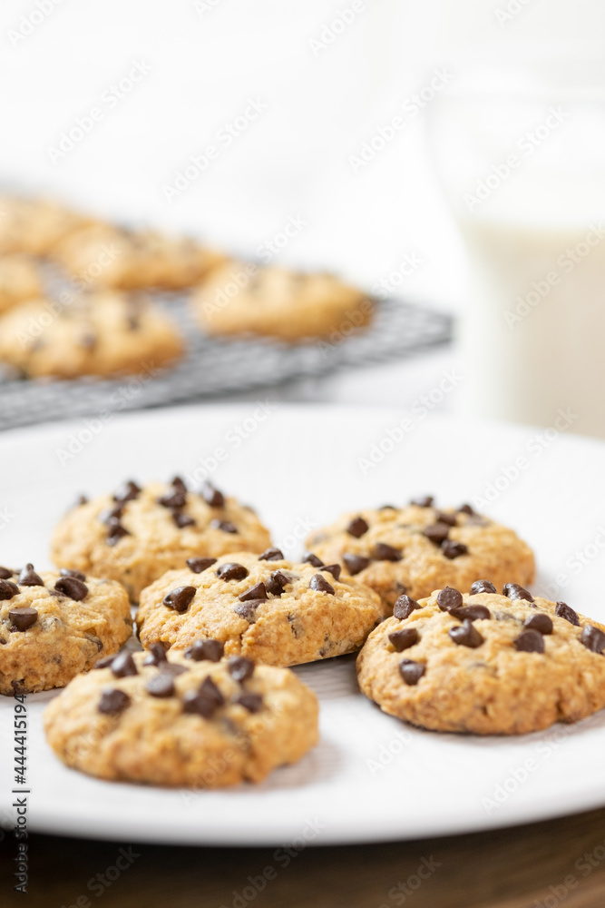 Delicious Whole Wheat Chocolate Chip Cookies set on white cafe table.