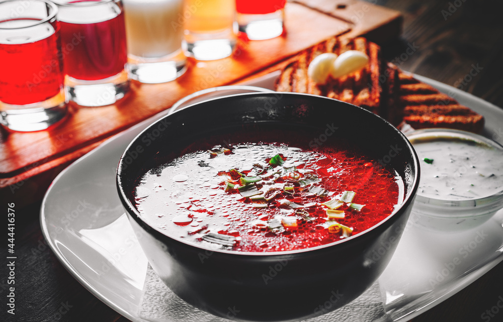 Beetroot soup Traditional Ukrainian or Russian borscht with sour cream in a bowl on wooden table