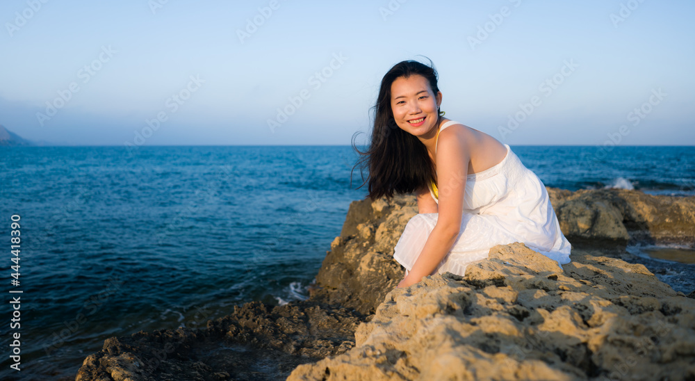 young happy and beautiful Asian woman by the sea - Attractive Korean girl cheerful enjoying relaxed summer holidays at tropical island in travel and lifestyle concept