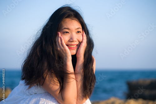 young happy and beautiful Asian woman by the sea - Attractive Korean girl cheerful enjoying relaxed summer holidays at tropical island in travel and lifestyle concept © TheVisualsYouNeed