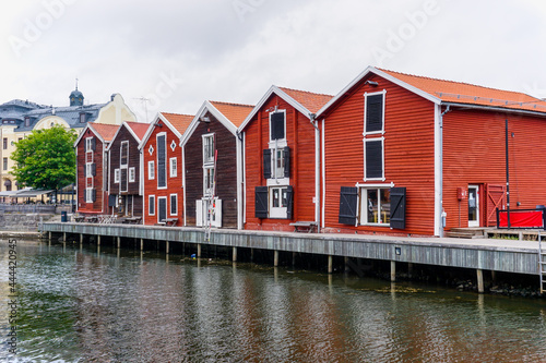 red and brown wooden warehouses along the waterfront in Hudiksvall photo