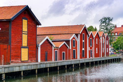red and brown wooden warehouses along the waterfront in Hudiksvall photo