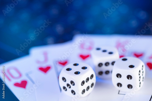 Online gaming platform, casino and gambling business. Cards and dice on laptop keyboard, toned in blue
