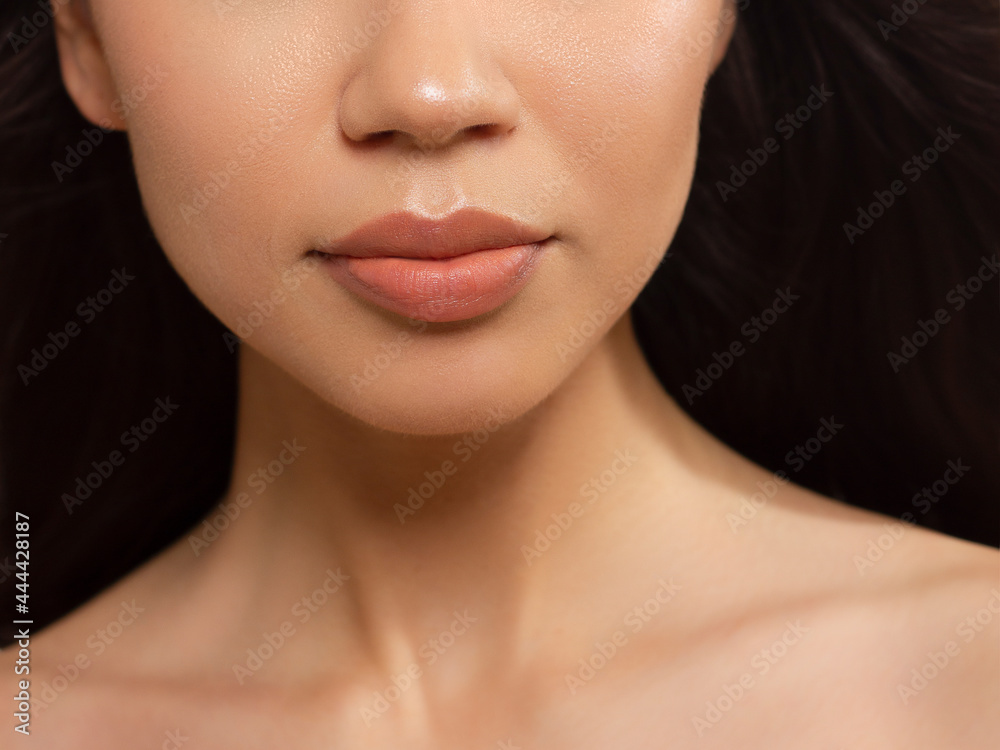 Obraz premium Sexual full lips. Natural gloss of lips and woman's skin. The mouth is closed. Increase in lips, cosmetology. Natural lips. Great summer mood with open eyes. fashion jewelry. Pink lip gloss