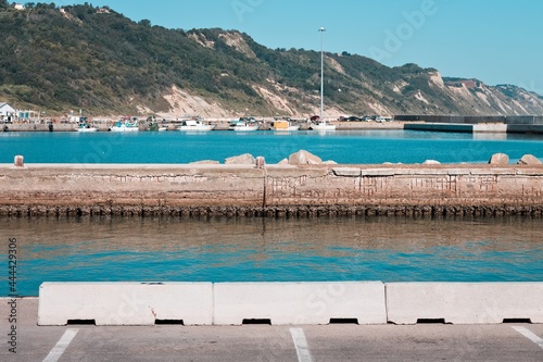 A reinforced concrete pier with concrete spalling in the port of Pesaro  Marche  Italy  Europe 