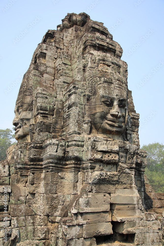Smiling stone face on tower at Bayon, Cambodia