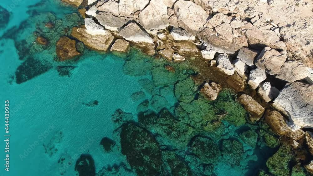 Rocky cliff on the seashore, Aerial top view 4k footage by drone of ocean blue water and rocks, Edge of the World and the blue sea beach, Dramatic geological wonder, Beautiful landscape
