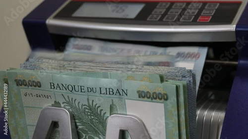 Lebanese Lira Currency being counted by a money counting machine. photo