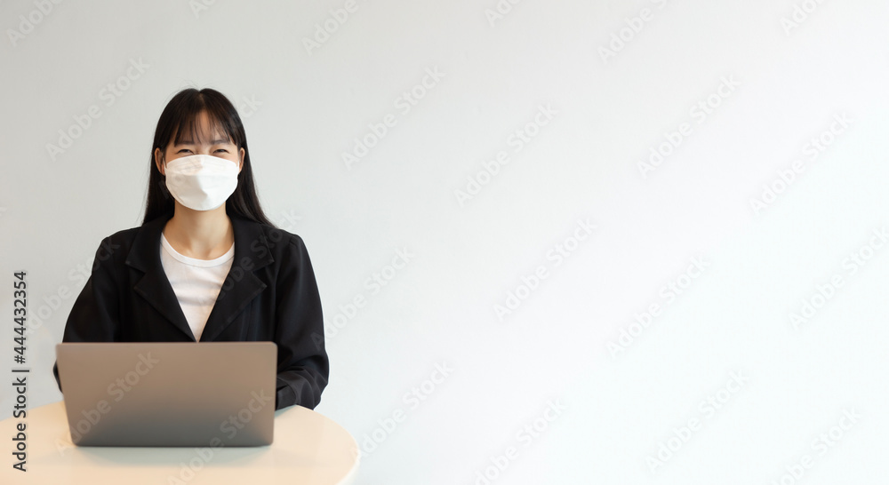 Young asian woman wear white mask and using laptop in white background. Beautiful asian woman wear white mask and working from home. selective focus on a woman. Young asian woman wear white mask and using laptop in white background. Beautiful asian woman wear white mask and working from home. selective focus on a woman.
