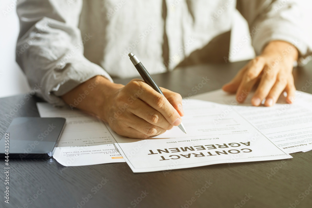 Business man signing document. Business man signing contract. Close up of business manager signing document on table. Business man signing document. Business man signing contract. Close up of business manager signing document on table.