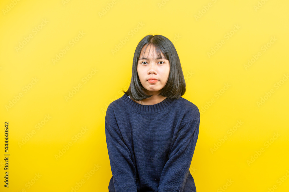 Portrait of a young beautiful woman in studio on yellow background. Portrait of a young beautiful woman in studio on yellow background.