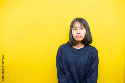 Portrait of a young beautiful woman in studio on yellow background. © stcom