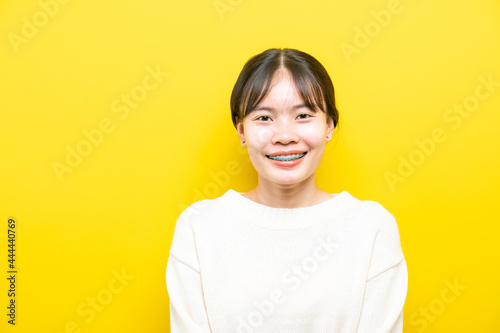 Photo of young attractive girl happy positive smile think hand touch chin isolated over yellow color background