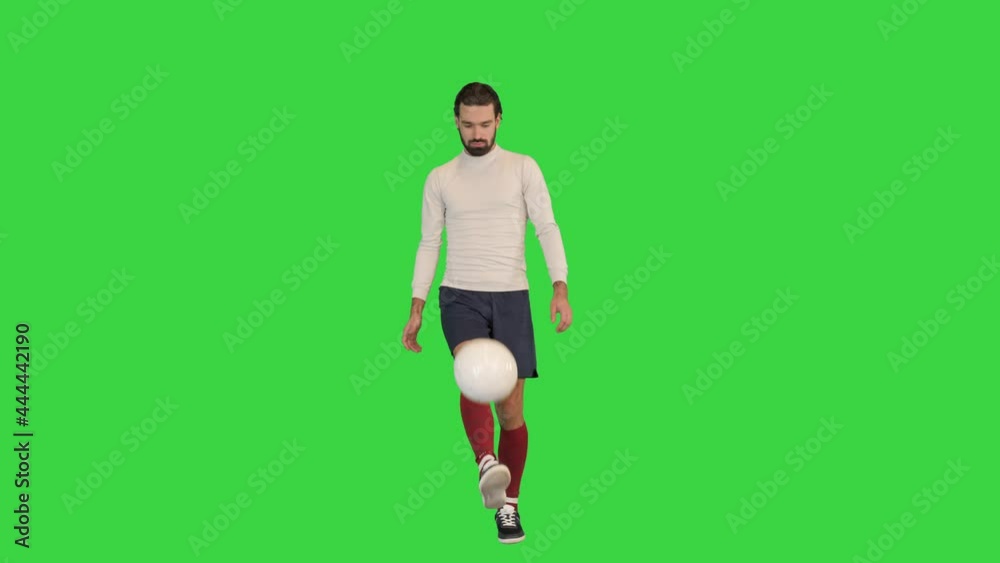 Soccer player holding and playing with a ball on a Green Screen, Chroma Key. Soccer player holding and playing with a ball on a Green Screen, Chroma Key.