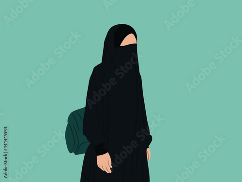A woman wearing a green burqa bearing a bag photo