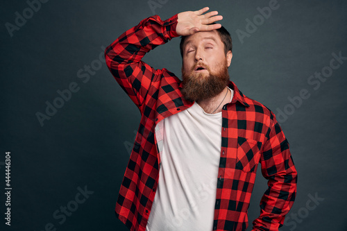 Phew guy relieved finally got rid of annoying guests. Tired handsome bearded man whiping sweat from forehead and exhale with satisfaction, glad something is over, worked hard, green-grey background photo