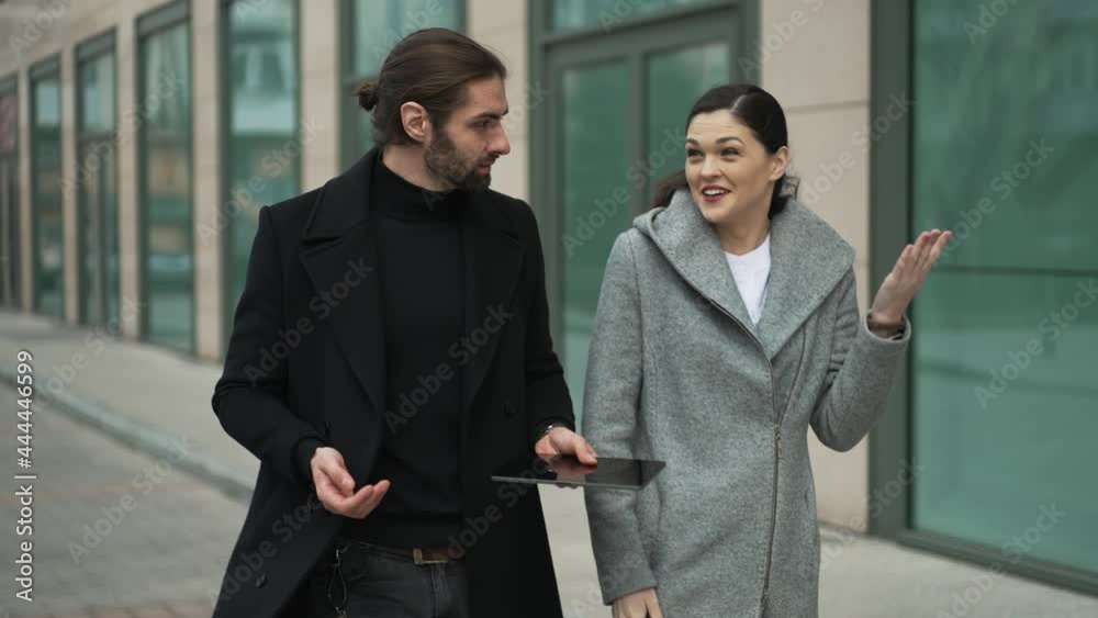 Business people walk down the street and talking