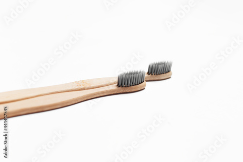 Studio picture of two wooden eco toothbrushes  isolated on white.