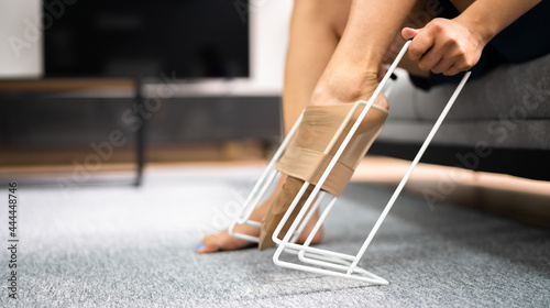 Canvastavla Woman Putting On Medical Compression Stockings