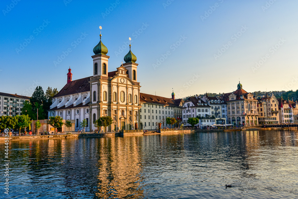 Beautiful view of Lucerne historic city center with Jesuit Church (Jesuitenkirche in German) and river Reuss on a sunset sky. Lucerne, Switzerland