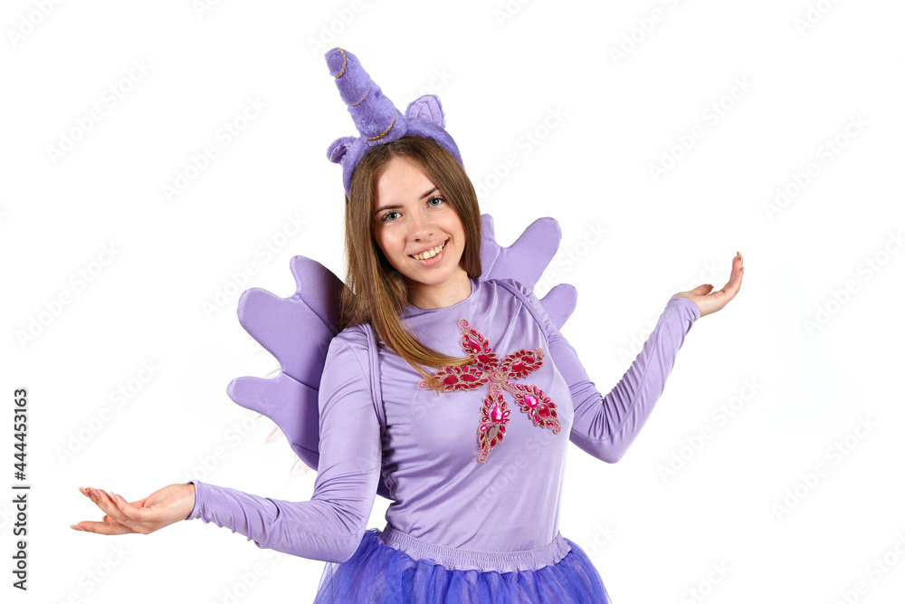 Girl in a purple unicorn costume in the studio on a white background. Girl in a purple unicorn costume in the studio on a white background.