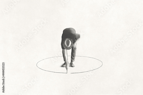 man drawing black circle 
around him with chalk, loneliness concept photo