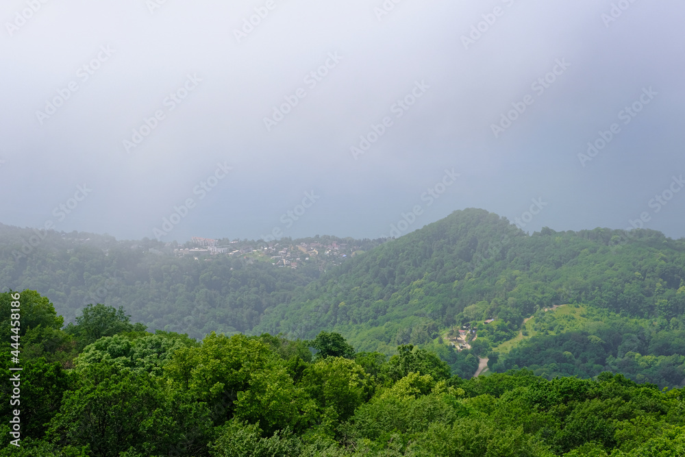 View of mountains and forest from above, mountain Akhun hills and forest in the morning fog