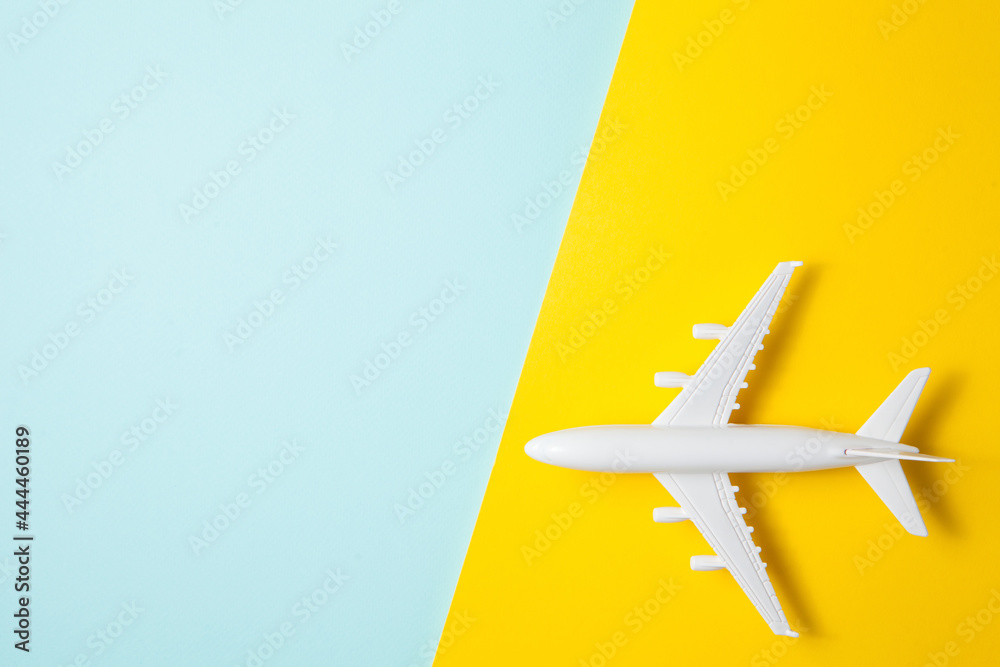 Flat lay design of travel concept with plane on yellow blue background. Flat lay design of travel concept with plane on yellow blue background.